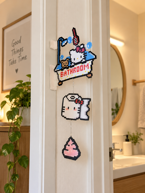 Bathroom kitty fuse bead wall hanging displayed on a door